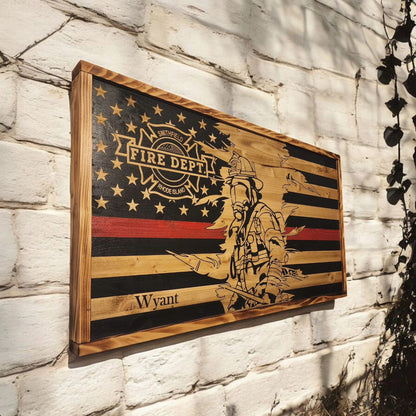 Wooden plaque with a firefighter design and 'Fire Dept' text on a stone wall.