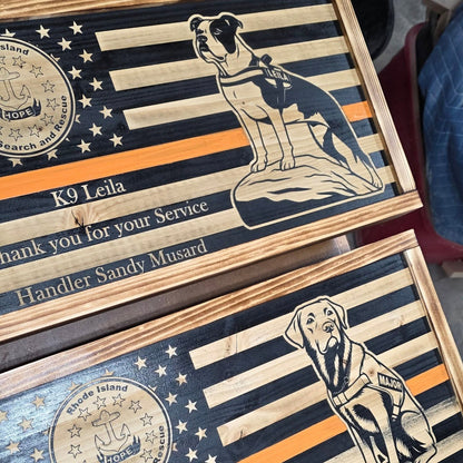 Wooden plaque with a dog illustration and engraved text on an American flag background